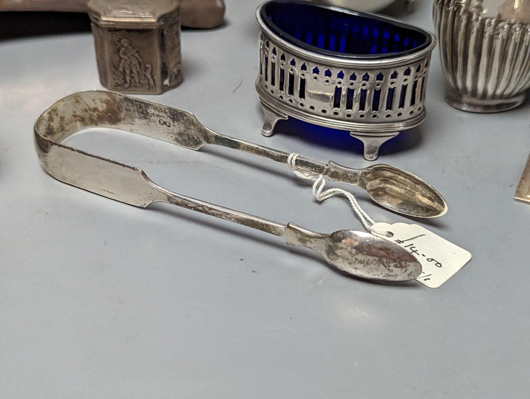 A group of assorted silver items including George V silver mounted hip flask(bruise), a pair of silver sauceboats(a.f.) one other sauceboat, sterling box, two silver cream jugs, cigarette box, salt, sugar tongs, brush an